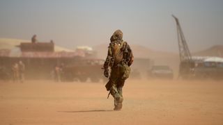 A photo of a person walking in the Mojave Desert during the post-apocalyptic Wasteland Weekend festival on September 28, 2019.