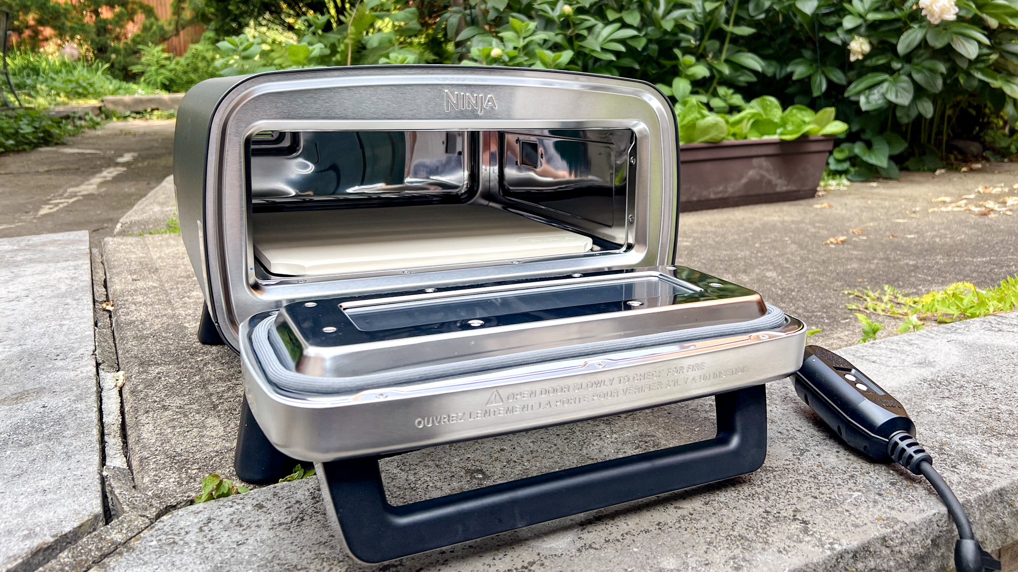 Ninja Artisan Outdoor Pizza Oven in a back yard