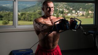 Man performing the low pulley cable cross-over chest exercise