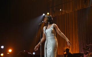 Aretha Franklin (Cynthia Erivo) performing on stage in a silver sequinned dress and a silver tiara