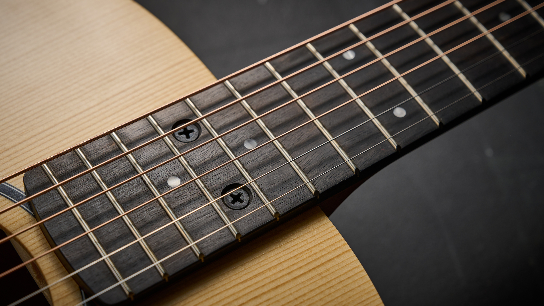 Close up of the bolt on neck of the Taylor BT1e Baby Taylor 3/4 acoustic guitar