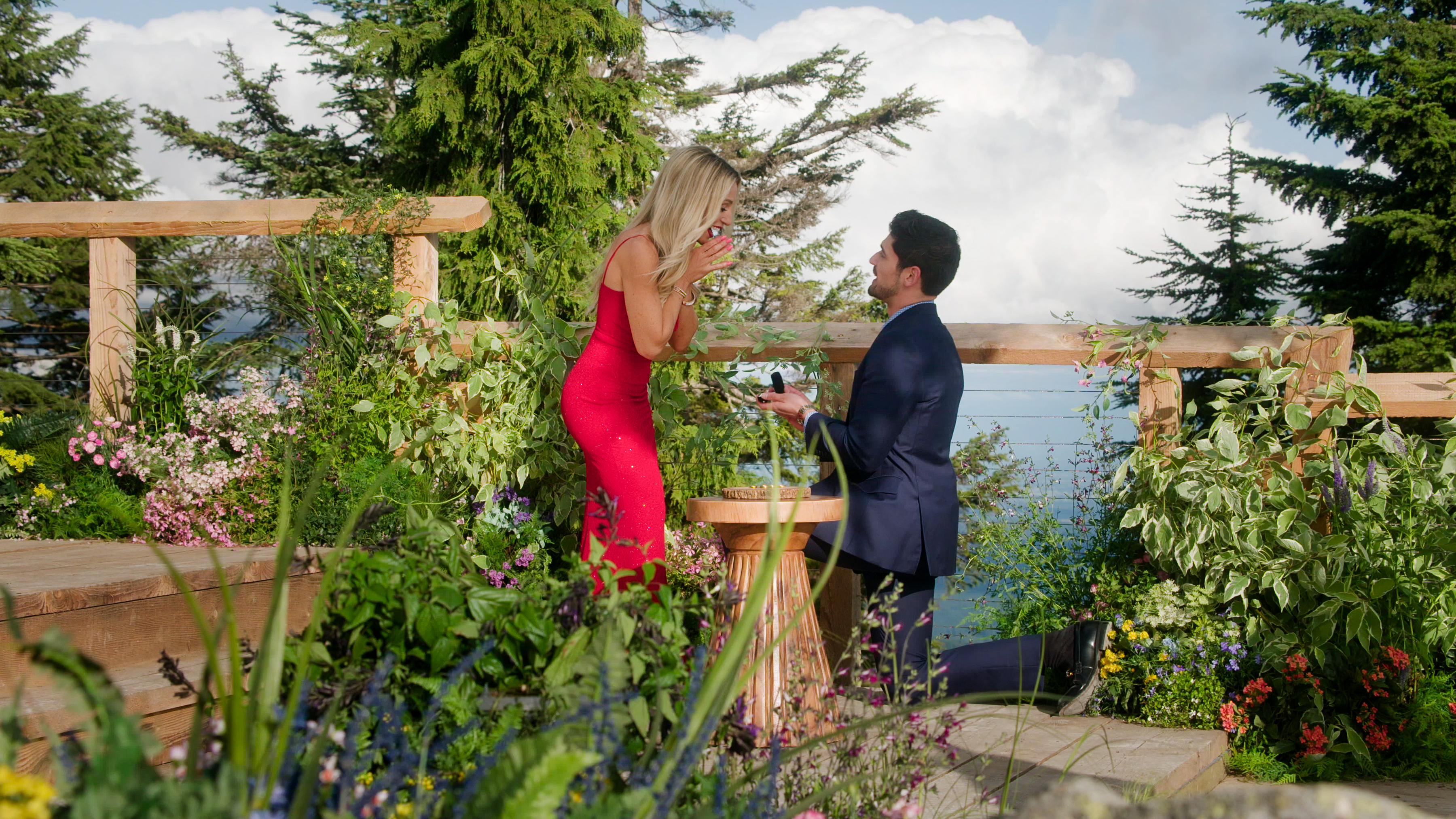 vanessa looks shocked as logan proposes to her on a balcony in the finale of age of attraction