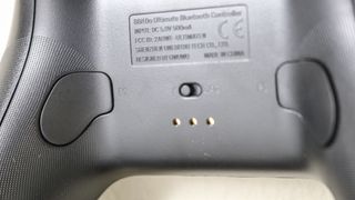A close-up shot showing the remappable buttons on the back of the 8BitDo Ultimate Controller