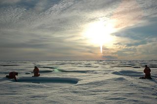 Arctic researchers with the midnight sun.