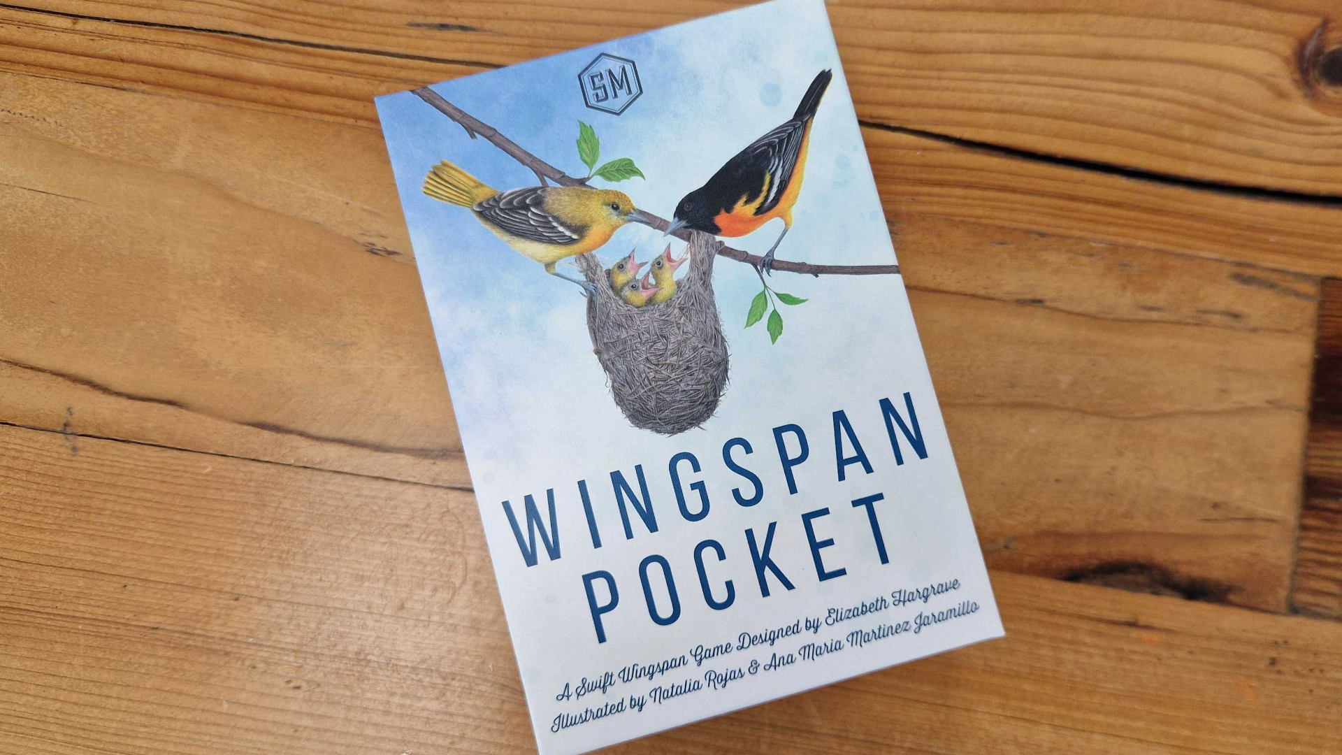 Wingspan Pocket box on a wooden table, seen from above
