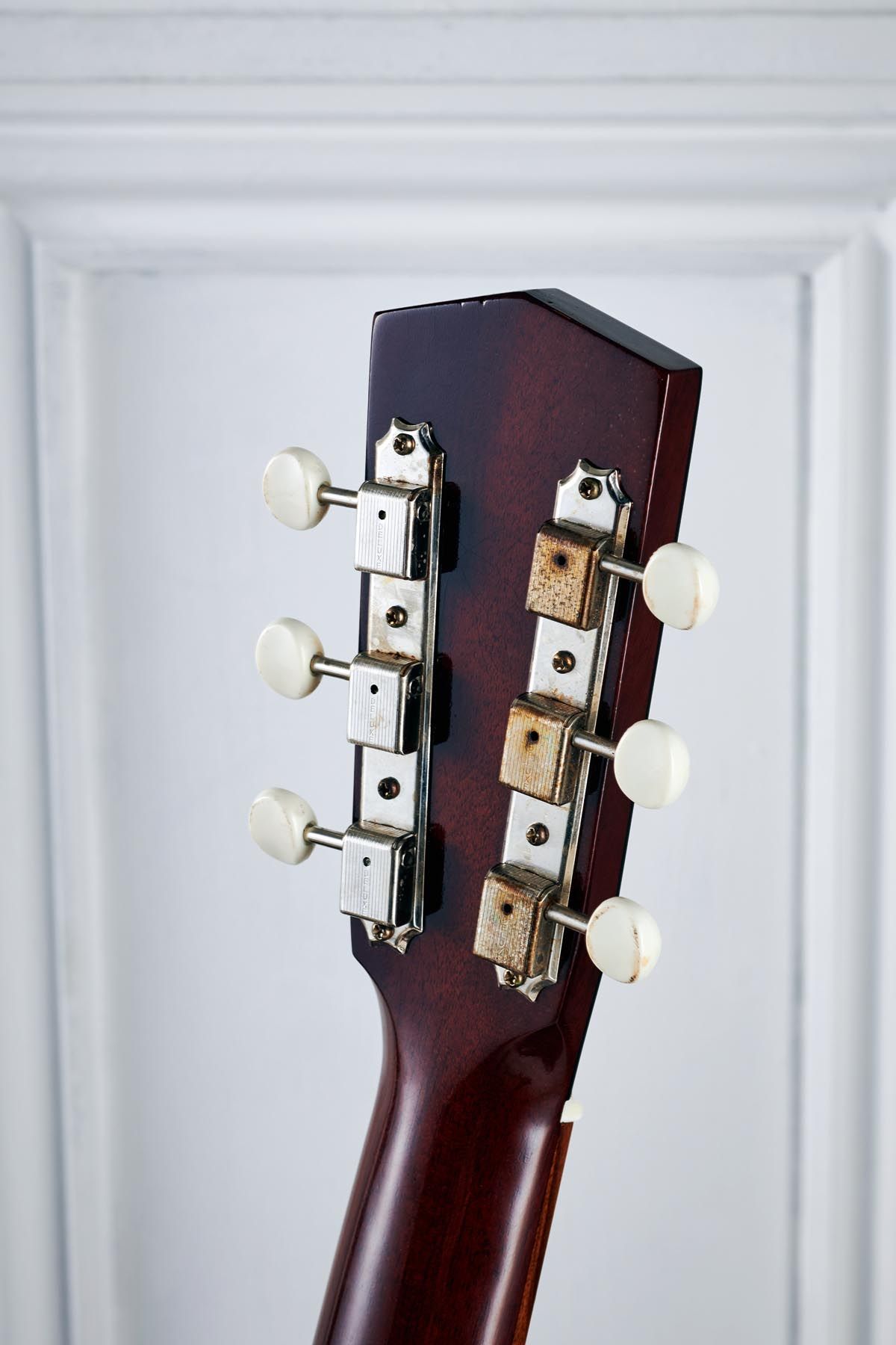 Vintage Kluson tuners with aged white plastic buttons.