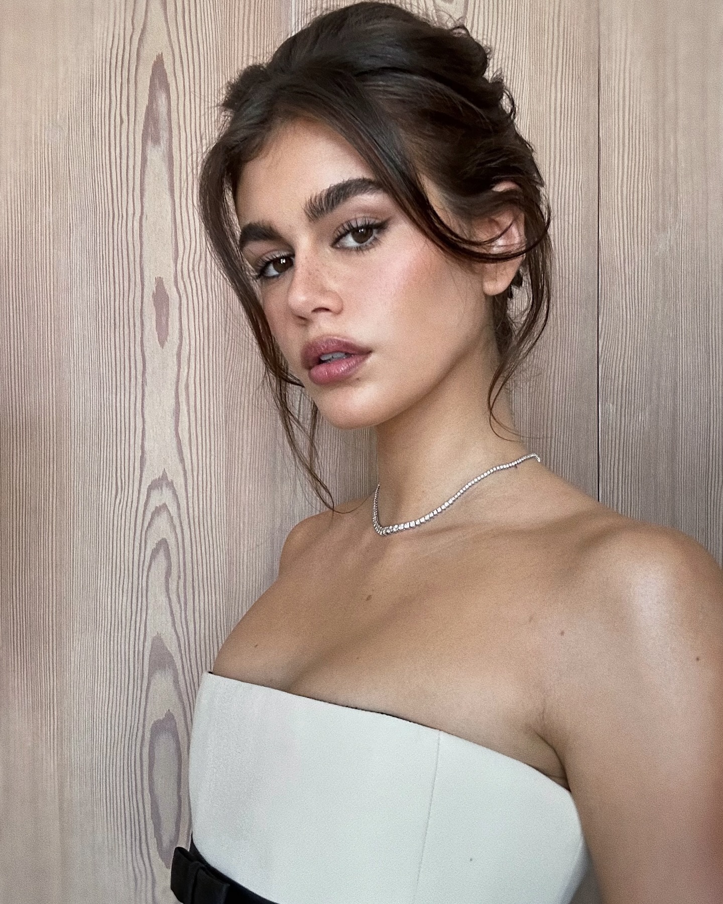 Kaia Gerber with French twist hairstyle