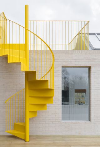 East London apartment revived by sparky yellow staircase