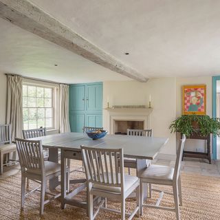 dining room with whitewashed beams table and fruits