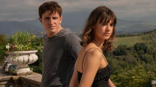 From left to right: Paul Mescal leaning his back against a rail while Daisy Edgar-Jones stands facing the rail in Normal People. 