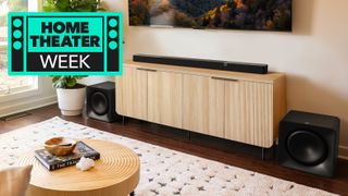 Klipsch Flexus Core 300 soundbar with matching subwoofers in a tastefully furnished apartment, with a sign saying Home Theater Week