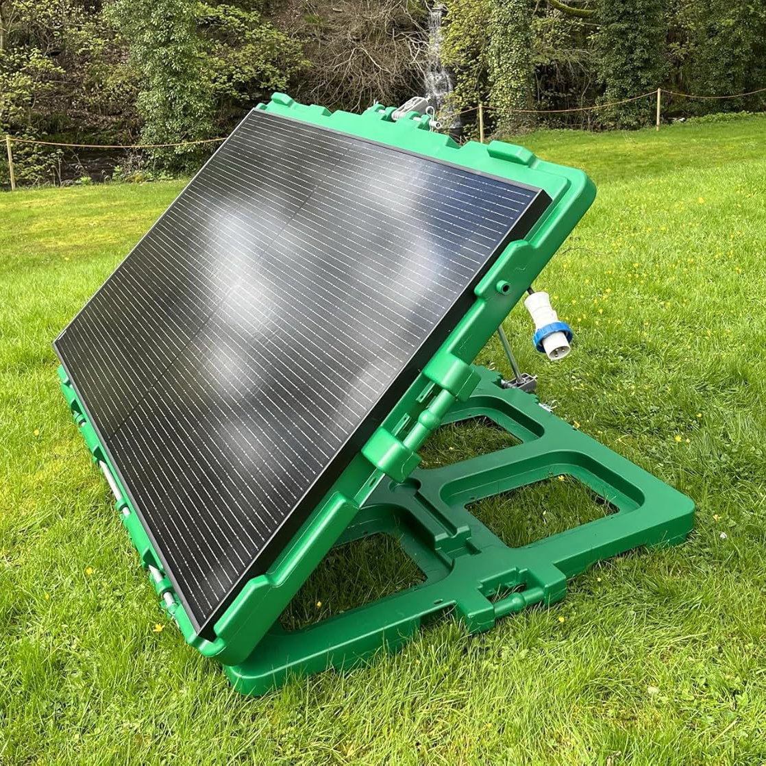 plug-in solar panel mounted in green frame stood on lawn