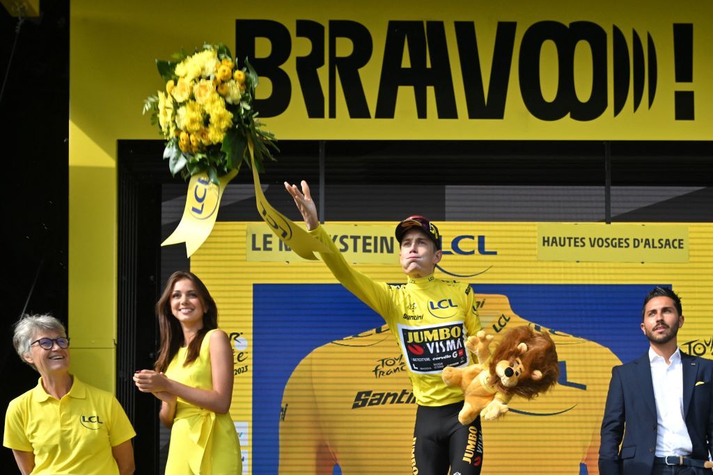 Jumbo-Visma&rsquo;s Jonas Vingegaard celebrates on the podium with the overall leader's yellow jersey after stage 20