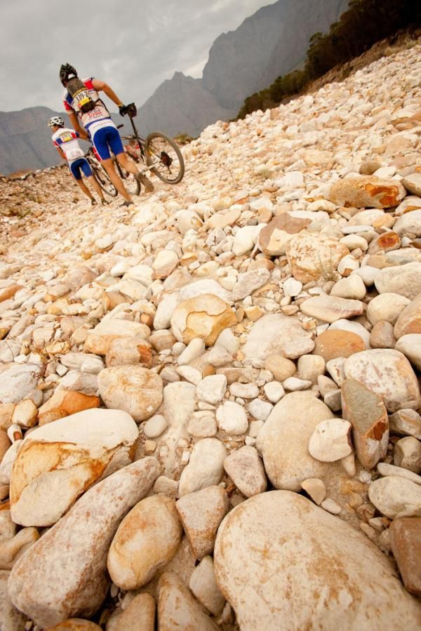 Riders crossing a boulder-field during stage 3