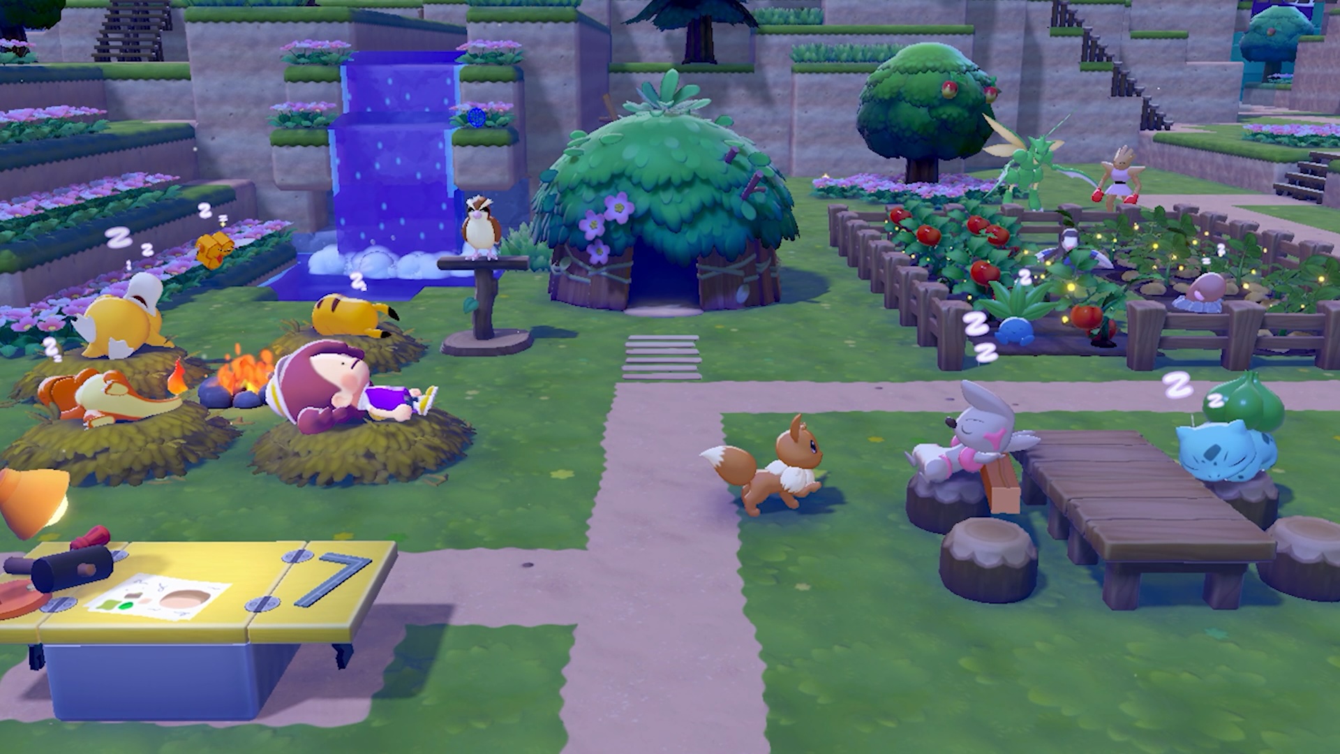 Pokemon Pokopia gameplay at night, showing various Pokemon gathered in a built-up area with a farm, small hut, and outdoor table with a waterfall running in the background
