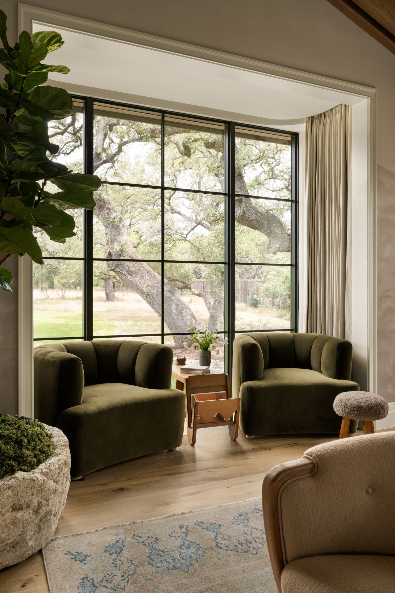 A window area with two green plump club chairs