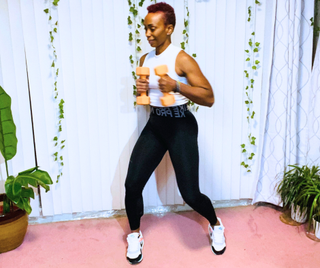 personal trainer Elethia Gay performs side-to-side jab with dumbbells
