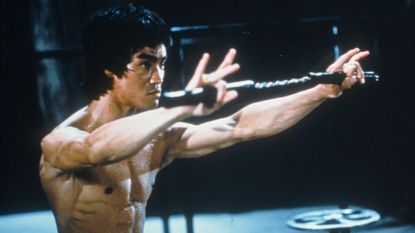 Chinese-American martial arts exponent Bruce Lee (1940 - 1973), in a still from the film 'Enter The Dragon', directed by Robert Crouse for Warner Brothers, 1973. (Photo by Fotos International/Archive Photos/Getty Images)