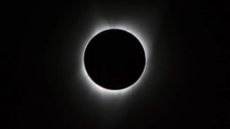 During the total solar eclipse, the Sun&rsquo;s visible-light corona (meaning crown), only visible at maximum eclipse from within the path of totality, is seen here as a crown of white light extending from around the edge of the eclipsing Moon.