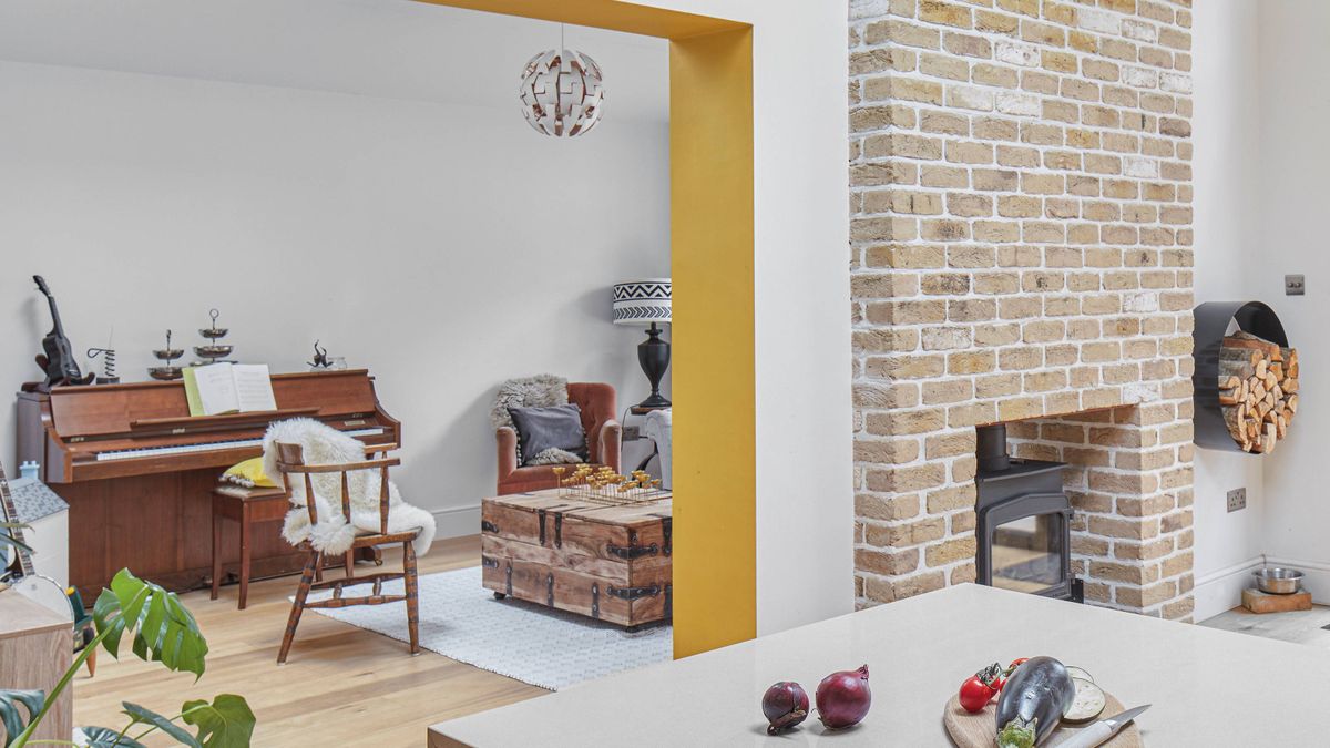 kitchen leading into music room with double sided fireplace