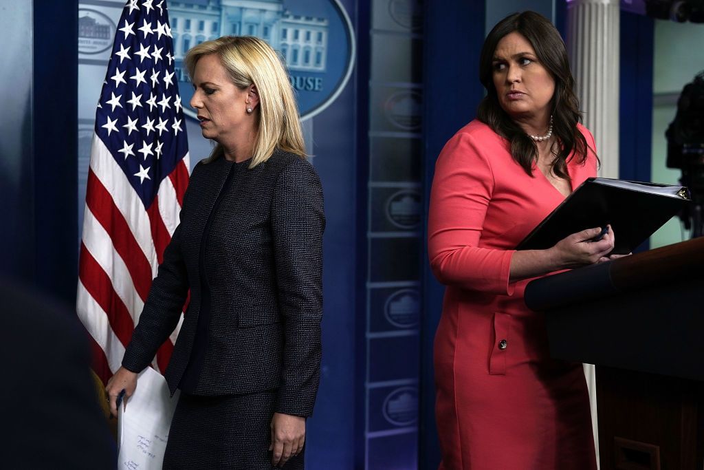 Sarah Huckabee Sanders looks at Homeland Security Secretary Kirstjen Nielsen