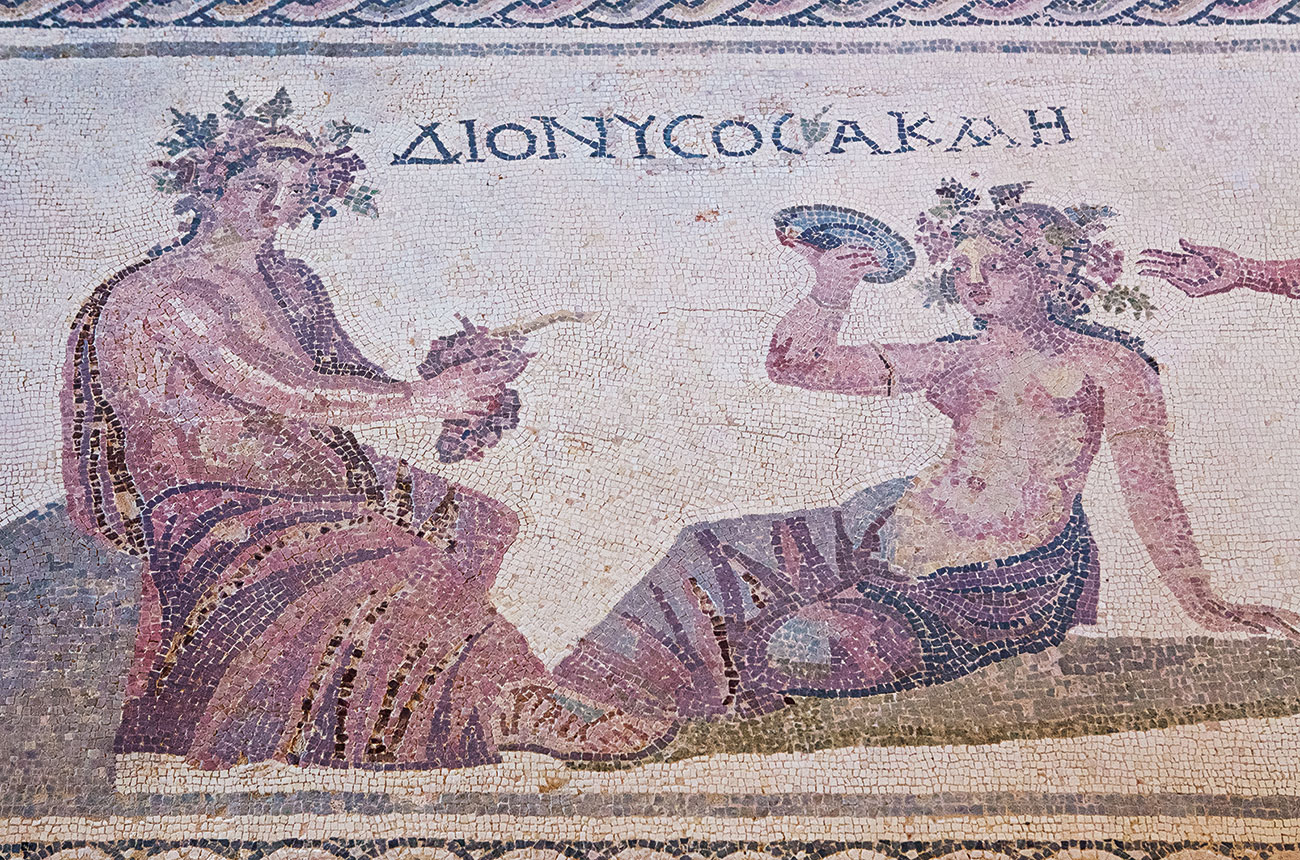 A Roman floor mosaic depicting Dionysus, the Greek god of wine, alongside the nymph Acme drinking wine from a cup.