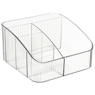 A clear fluted plastic vanity organizer with several seperated compartments, lower front and raised back. 