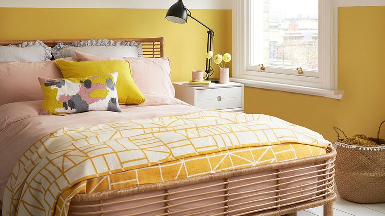 bedroom with sunshine yellow and white wall and bed