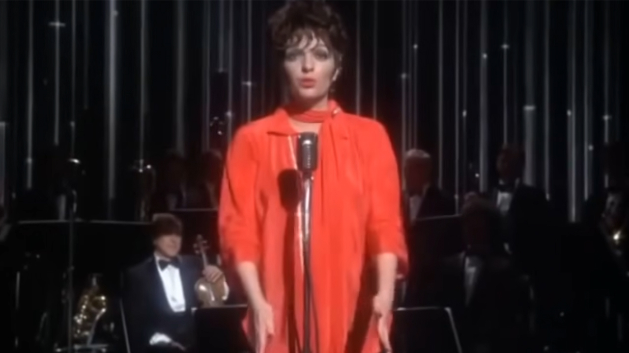 Liza Minnelli in a red dress, singing in New York, New York.