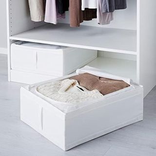 An IKEA Skubb box with jumpers neatly folded and stored in them