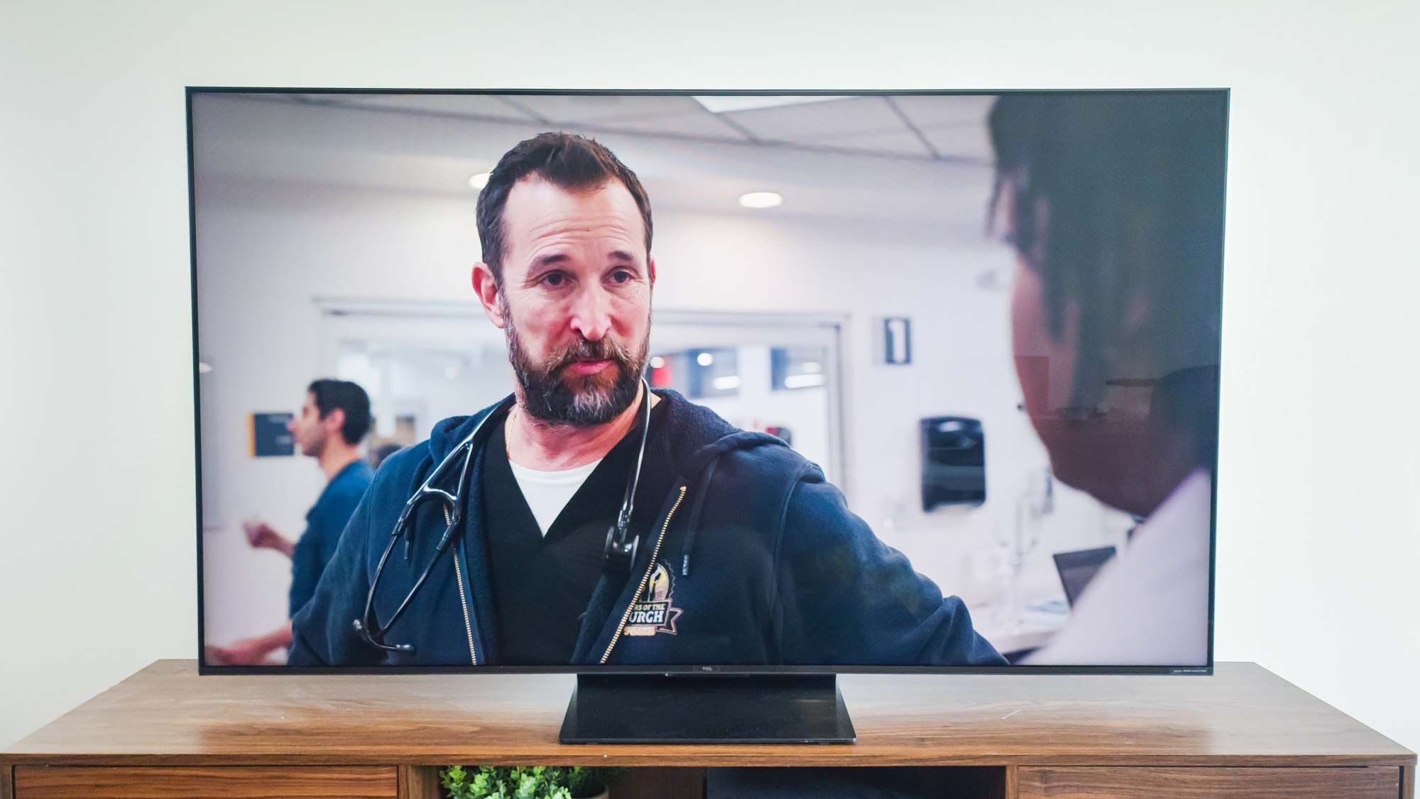 A TCL QM7K QD-Mini LED TV on a side table