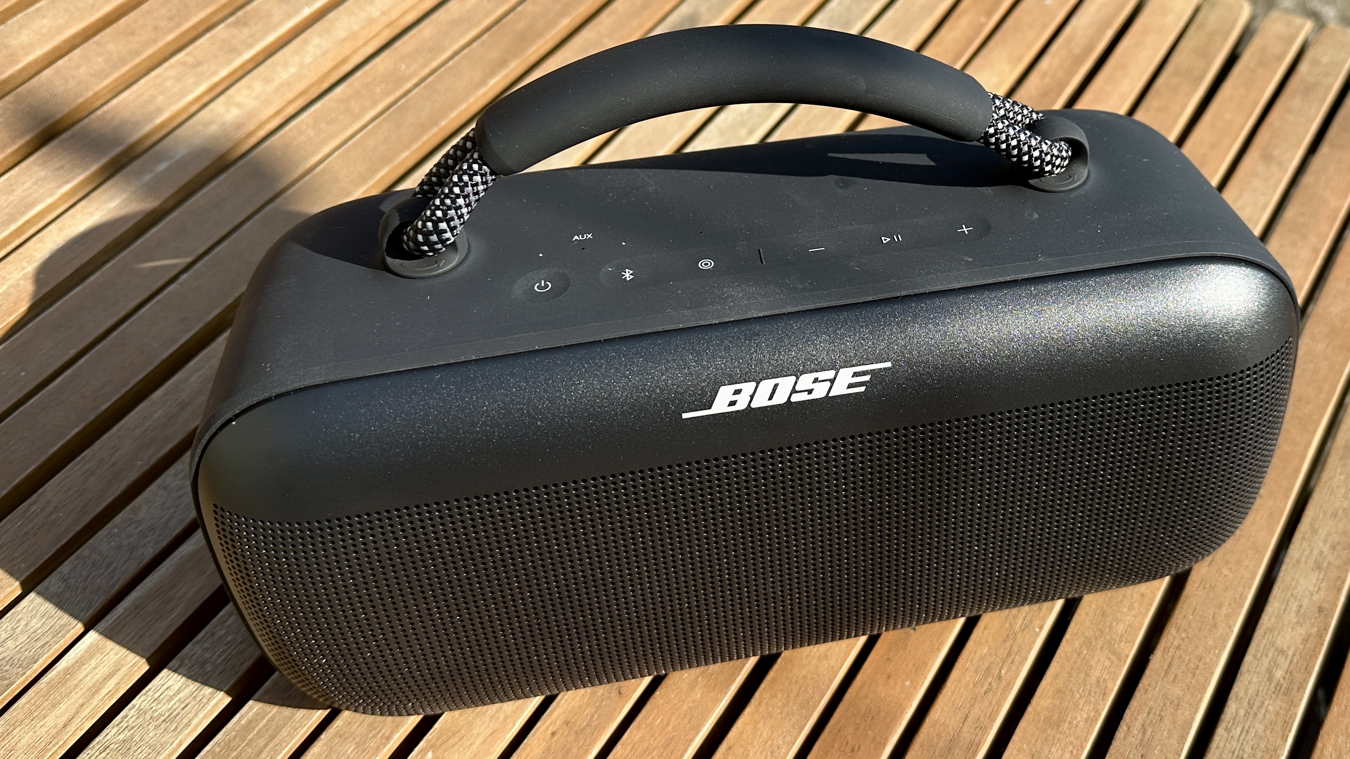 Bose SoundLink Max Bluetooth speaker on wooden table