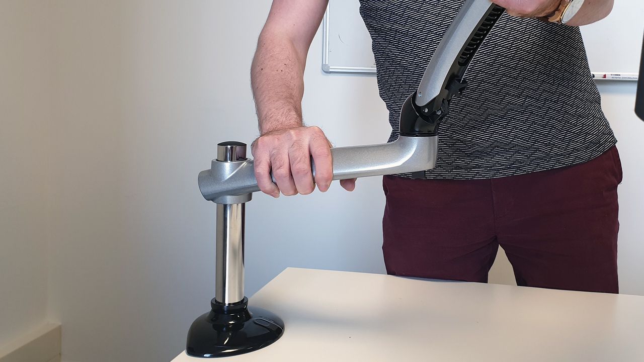 Taking into consideration the combined weight of the monitor and arm, it is easy to attach and the desk clamp pole immediately takes all the weight while you adjust.