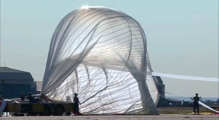 This still from a Red Bull Stratos webcast shows ground crew members inflating the 55-story helium balloon that will carry daredevil Felix Baumgartner to his 23-mile target altitude for his supersonic skydive, which would be the world&#039;s highest skydive, o