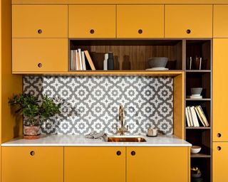 yellow midcentury modern style with patterned tile backsplash and marble countertop pelham kitchen by naked kitchens