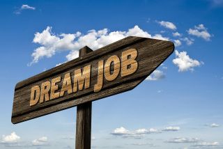 A sign with the words "dream job" on it
