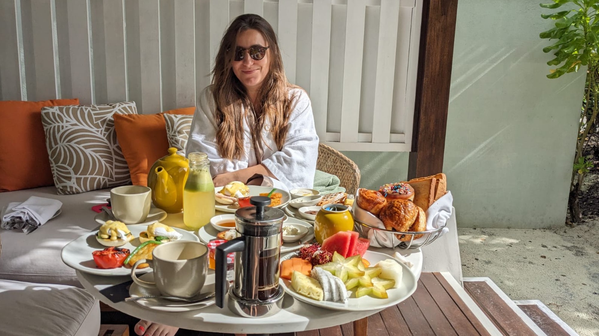 Woman sitting in front of breakfast spread