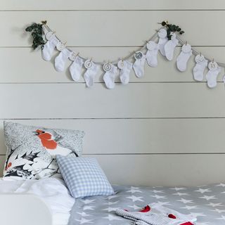Baby socks hanging from the wall, used as an advent garland