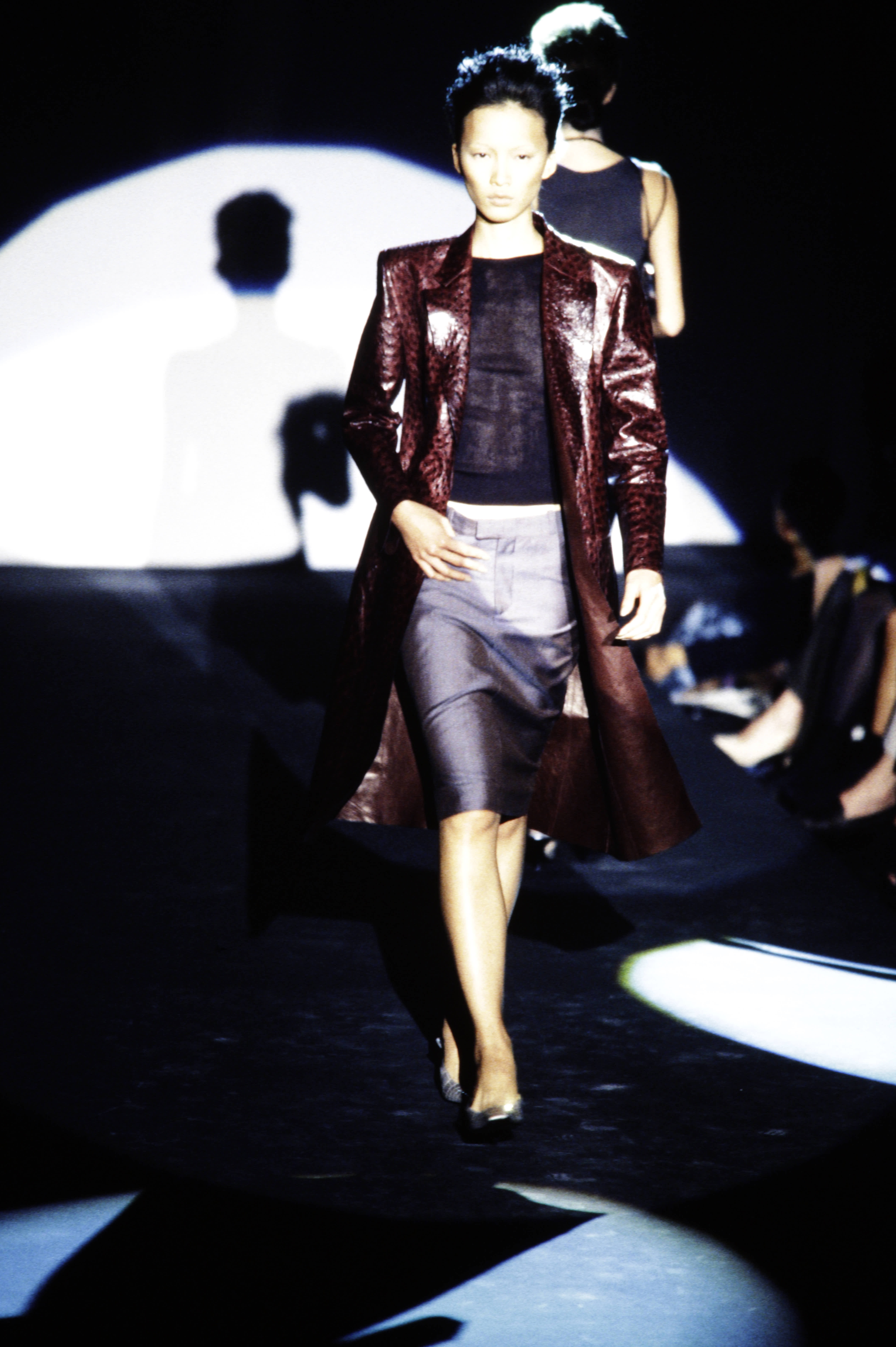 Model Ling Tan walking in the spring 1998 Gucci show wearing an ostrich leather car coat.