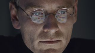Michael Fassbender sits in front of a computer screen in Steve Jobs