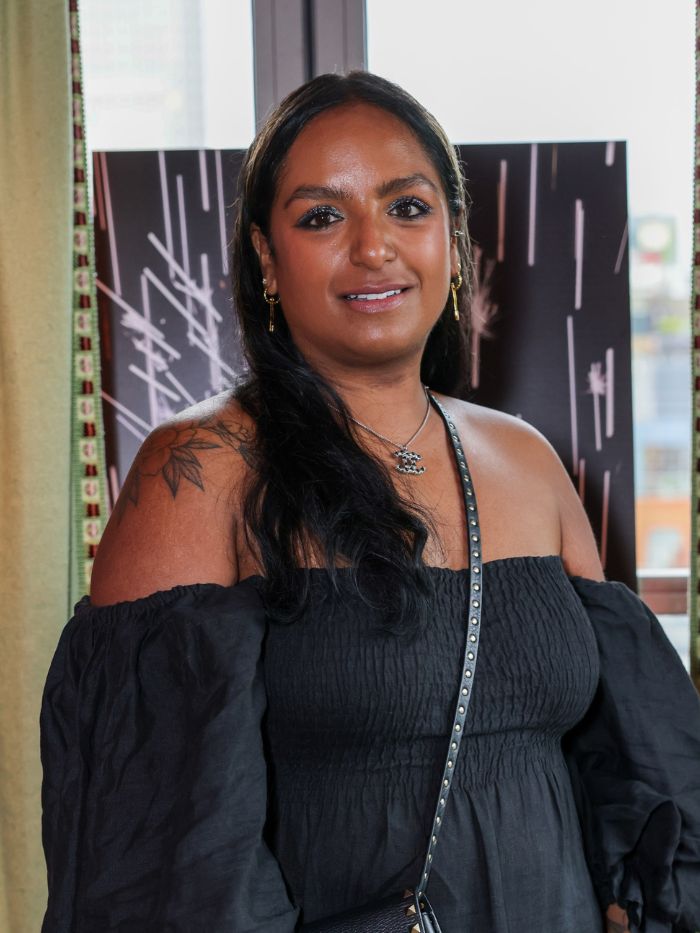 A picture of Anita Bhagwandas wearing a black dress at an event
