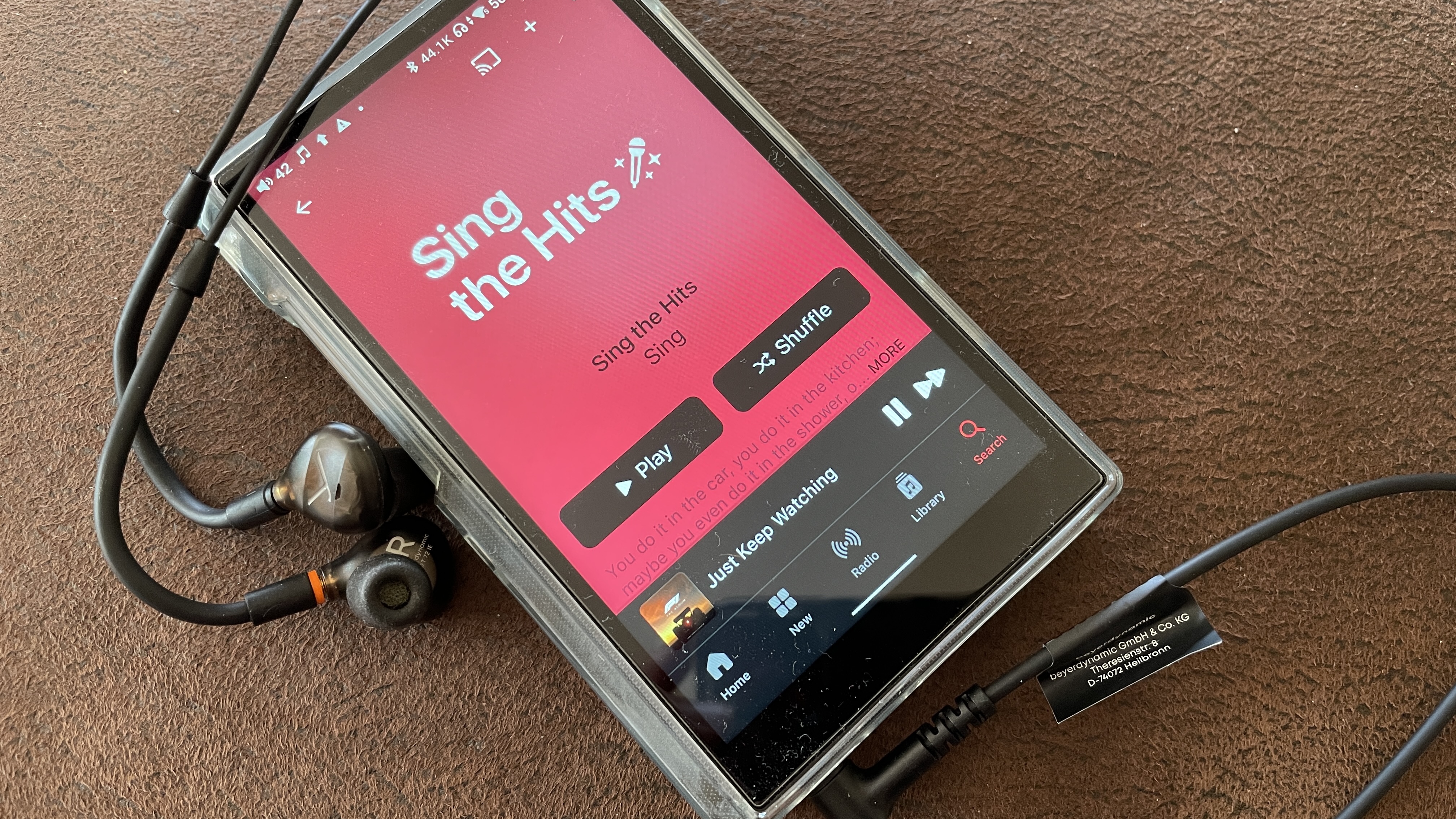 Beyerdynamic&#039;s DT 72 IE earbuds for vocals and guitar on brown background, showcasing the accessories