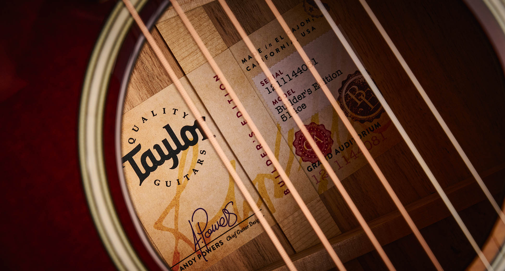 Taylor Builder’s Edition 514ce Kona Burst pictured against a wooden floor and patterned rug.