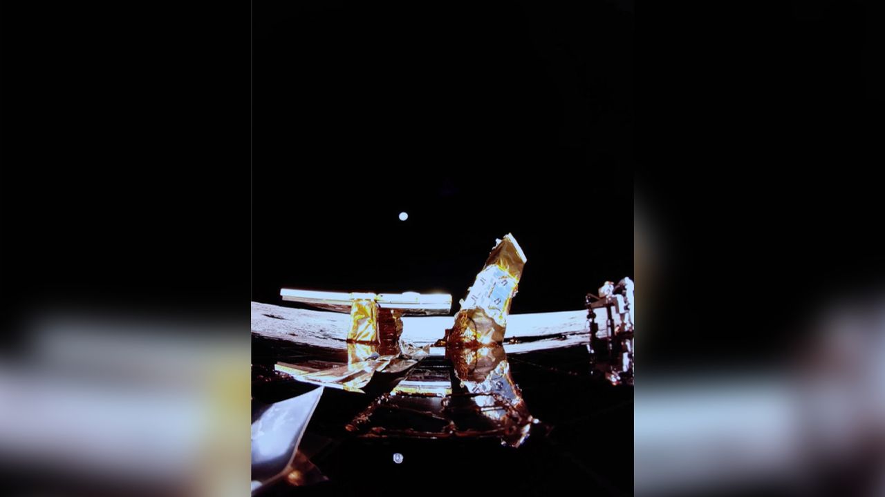 Blue Ghost lander on the surface of the moon with a pale blue dot - Earth - in the background