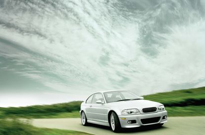 Car driving on road with clouds