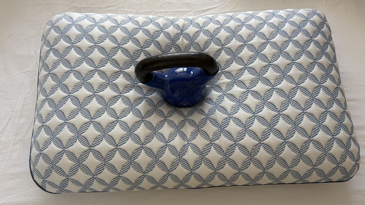 A 10lb weight balanced in the middle of the Helix Cooling Memory Foam pillow, in our reviewer's bedroom