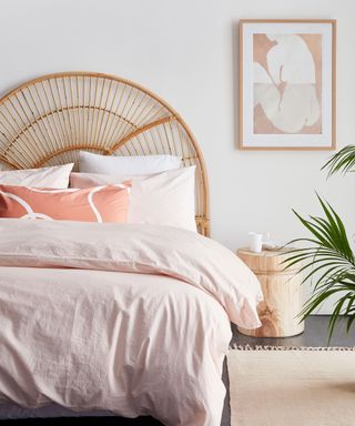 bright bedroom with wicker headboard and pink bedding