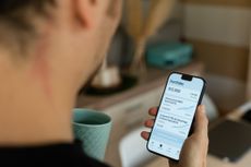 investor checking his stock market portfolio performance on a mobile finance app