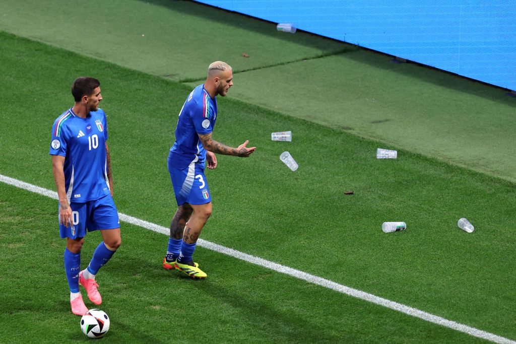 Federico Dimarco of Italy throws plastic beer cups off of the pitch during the UEFA EURO 2024 group stage match between Croatia and Italy at Football Stadium Leipzig on June 24, 2024 in Leipzig, Germany. 