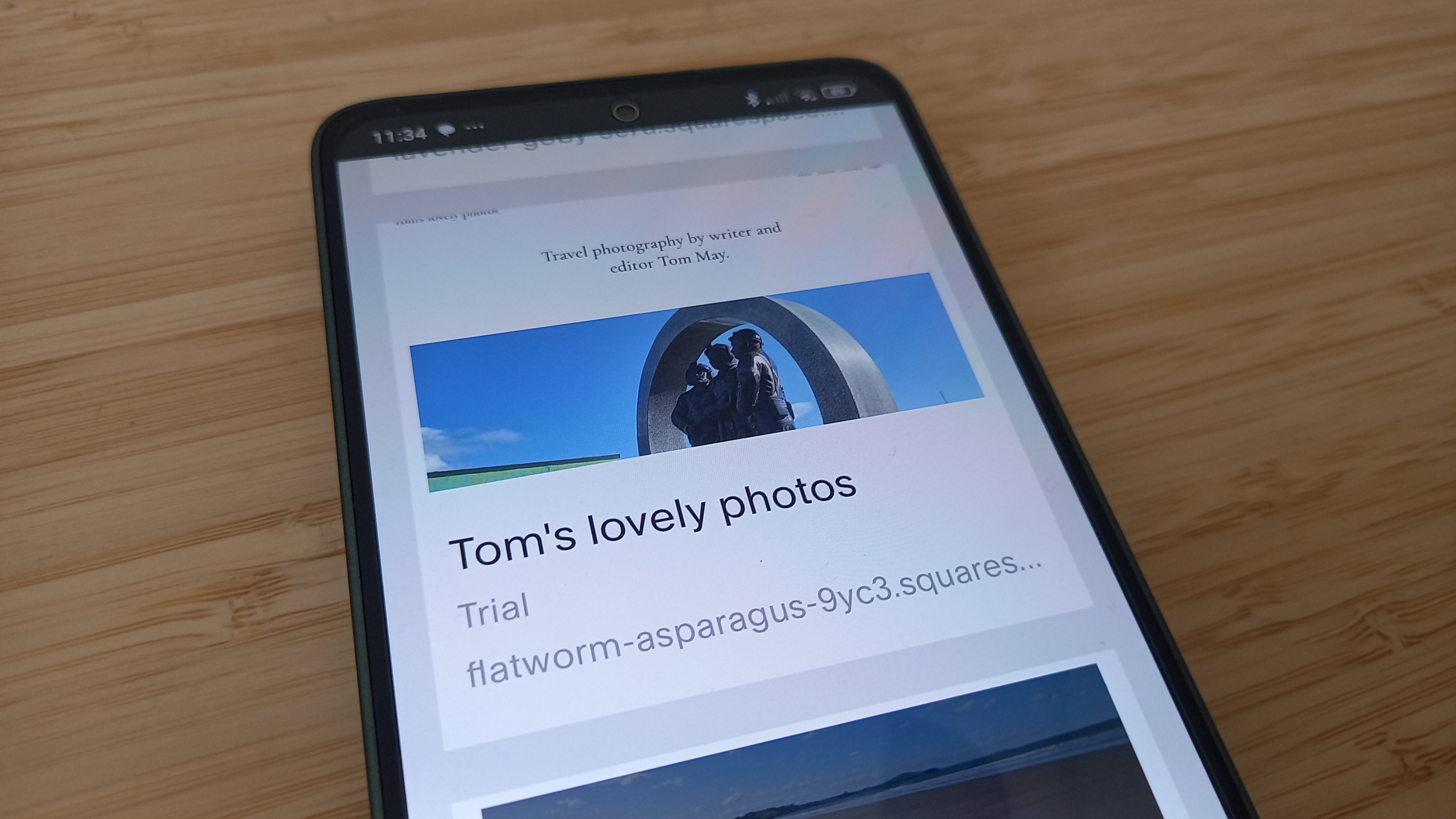 Website being edited in Squarespace on mobile phone on desk